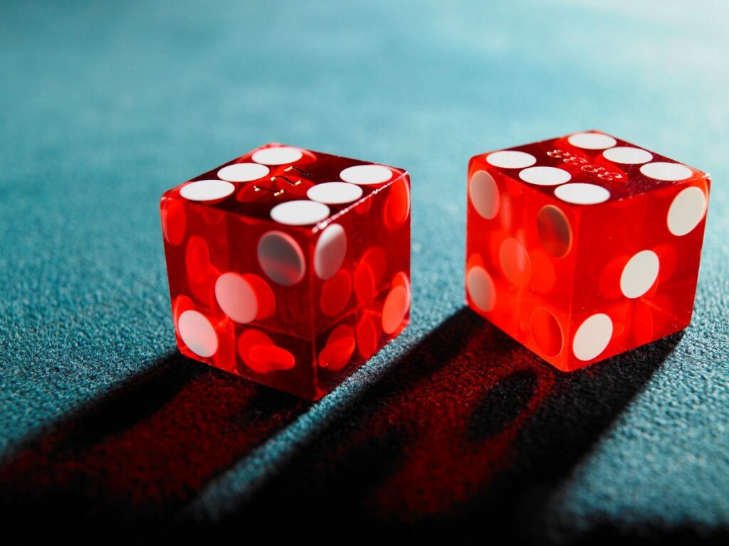 A picture of a set of dice on a green felt