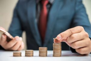 a man in a suit stacking up coins