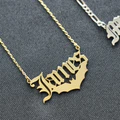 A picture of a gold necklace with the name "James" on it next to a silver one